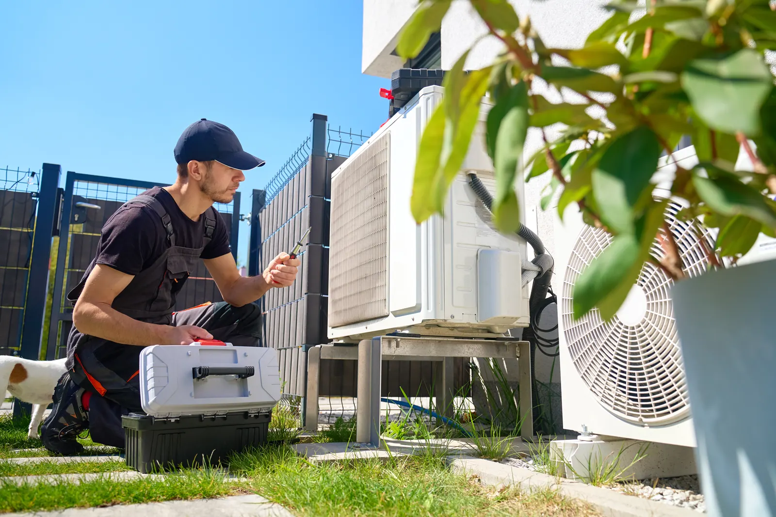 Technician inspecting an outdoor air conditioning unit